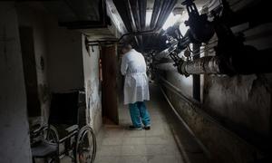 A doctor walks in a basement used to hide patients during air raids, at the Central District Hospital in Brovary, Ukraine.